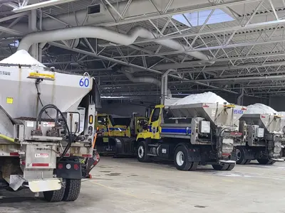 Multiple highway operations plows filled with salt in main shop garage