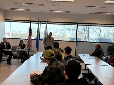 Students listening to presentation by fleet and administrative employees