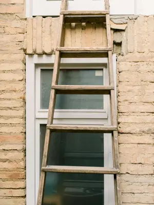 Ladder Leaning Against Home Window